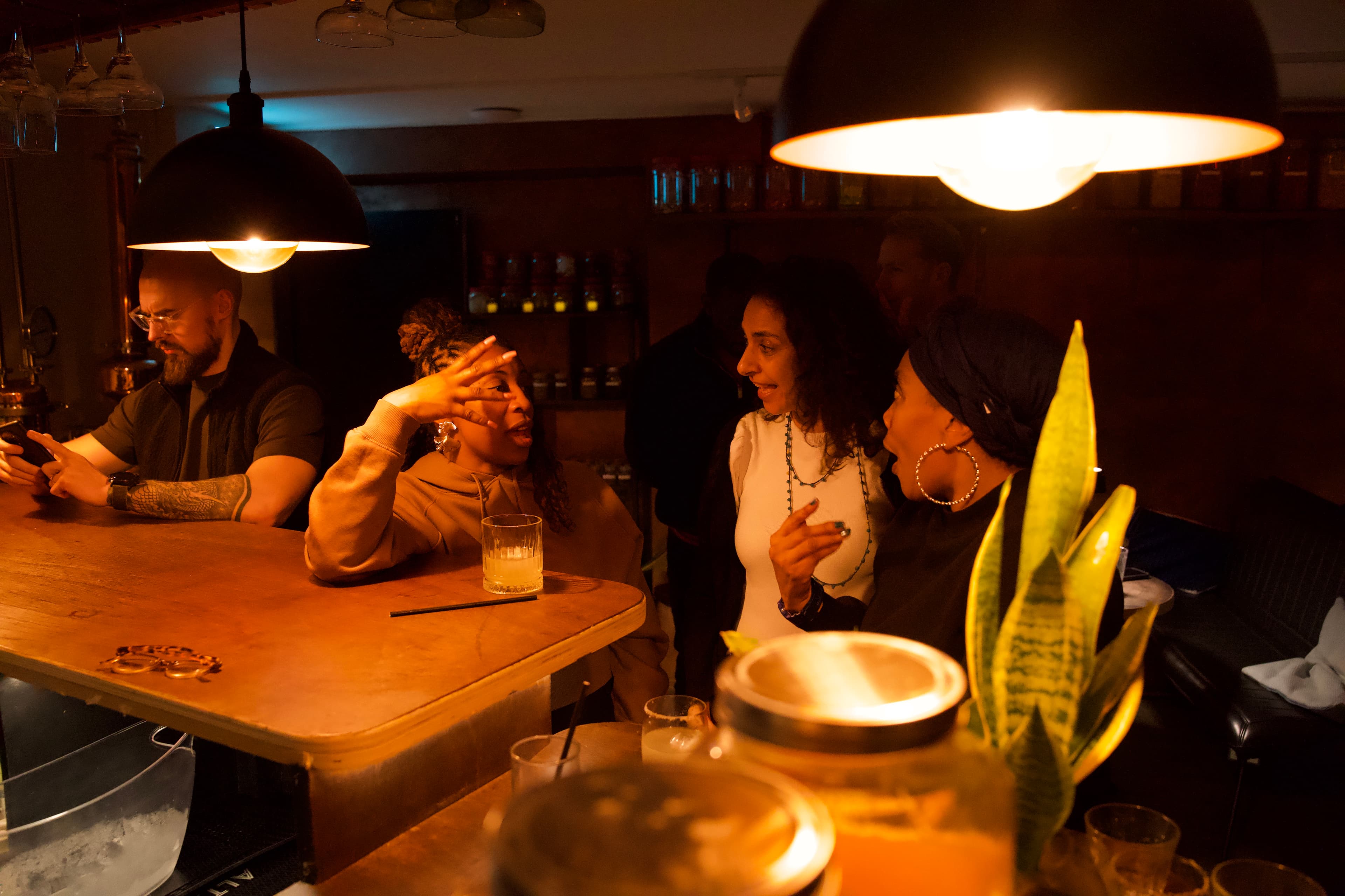 Members at the BCC Bar in the evening — conversation over cocktails, warm pendant lighting