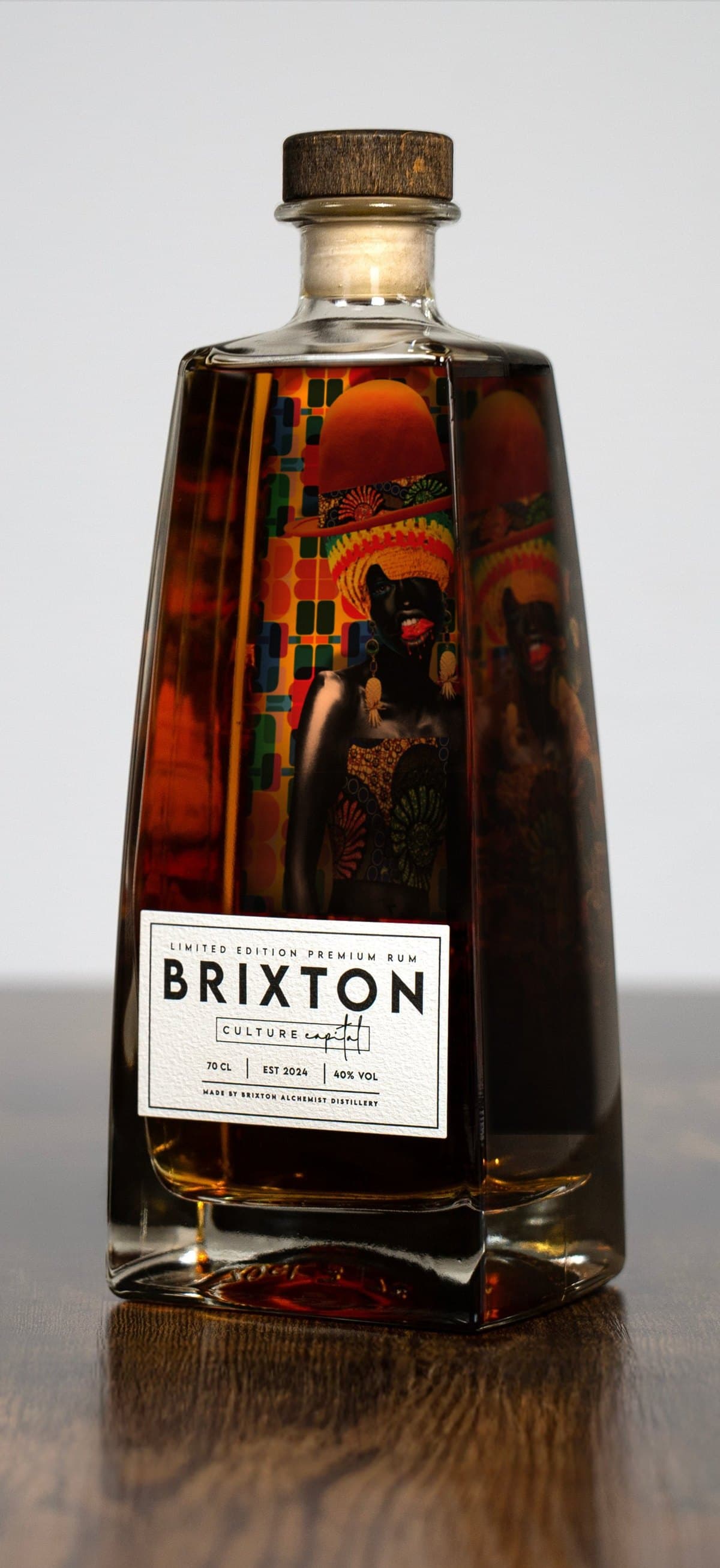 Brixton Culture Capital Rum × Chinakwe — the house bottle with Caroline Chinakwe's portrait showing through the rum