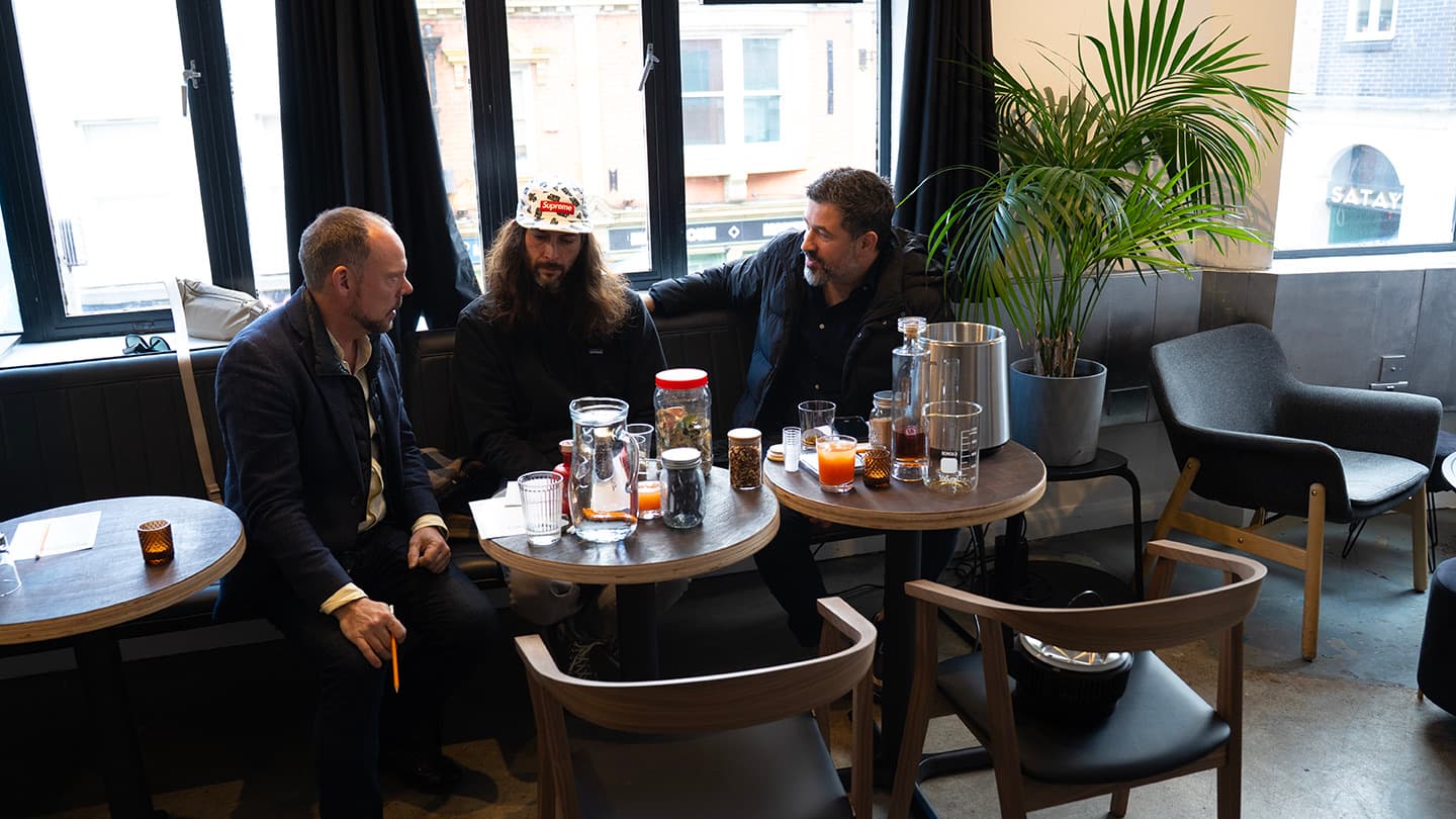 Guests settling in around the distillery tables with coffee, juices and jars of spices