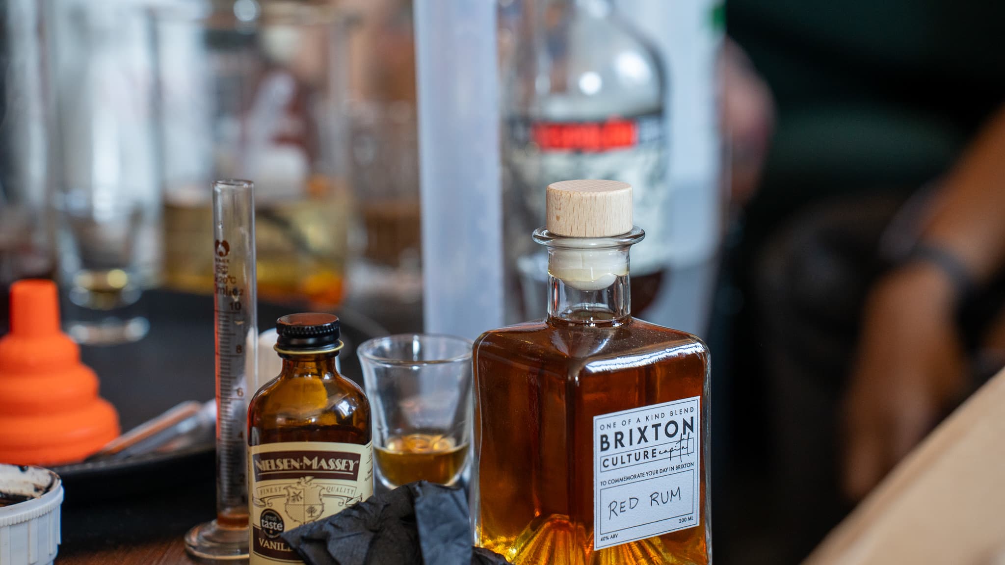 A bottle of Brixton Culture Capital red rum on the bar beside a tasting glass