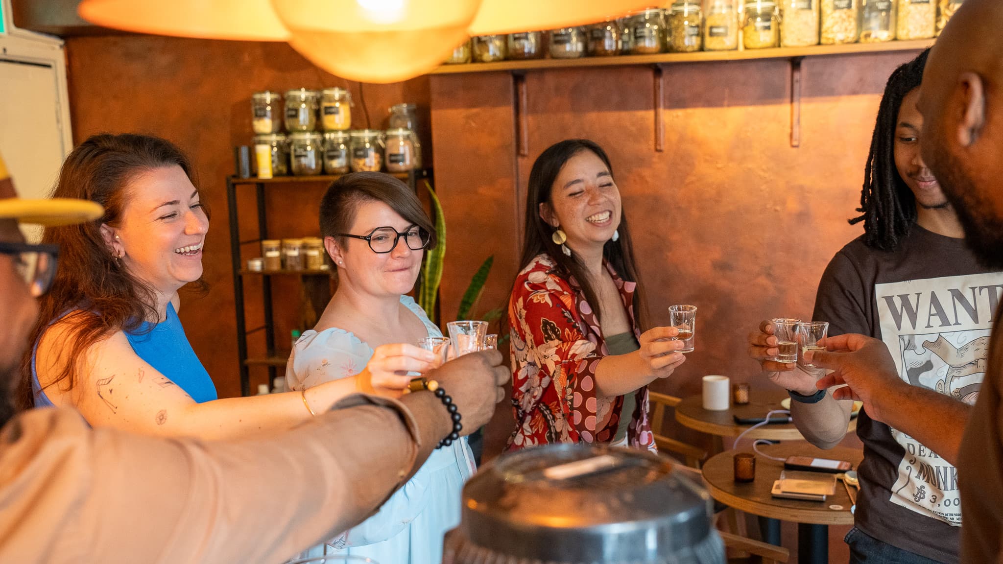 Guests clinking tasting glasses at the bar